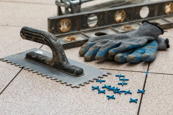 Installation of floor tiles. Ceramic tiles and different tools